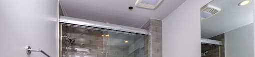 a bathroom with a shower and a toilet and a sink