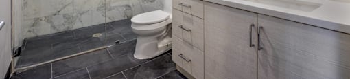 a bathroom with a toilet sink and shower