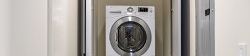 a front loading washer and dryer in a laundry room