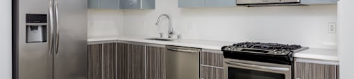 a kitchen with stainless steel appliances and a stainless steel refrigerator