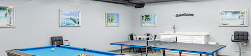 two pool tables and two ping pong tables in a room with other tables