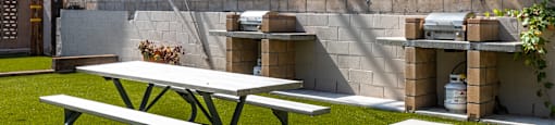 a picnic table and a bench in a backyard