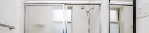 a small bathroom with a shower and a sink