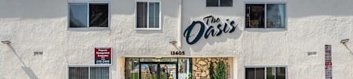 the oasis building on the corner of a street