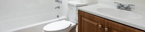 an empty bathroom with a sink toilet and shower