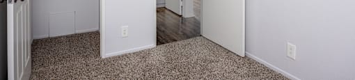 A white door is open to a hallway.