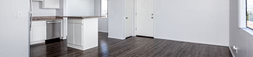 A room with wooden floors and white walls.