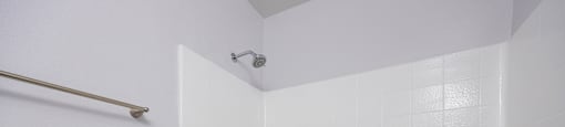 A white bathroom with a tub and toilet.