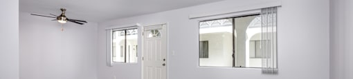 A room with a wooden floor and a ceiling fan.