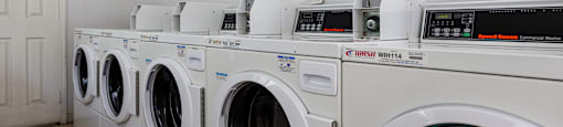 A row of washing machines in a laundromat.