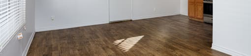 A room with wooden floors and white walls.