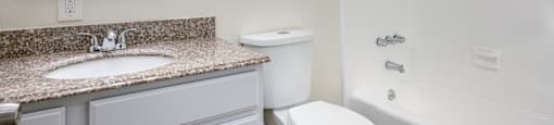 a bathroom with a sink toilet and a bath tub