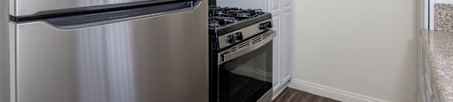a kitchen with stainless steel appliances and a refrigerator
