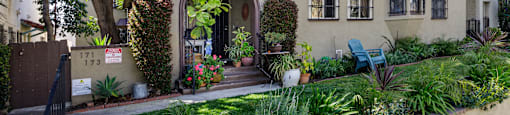 a house with an arched doorway and a garden outside of it