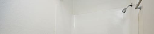 A white toilet and bathtub in a bathroom.