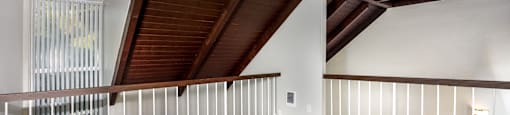A room with wooden floors and a balcony with white railings.