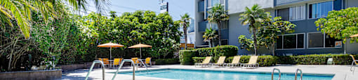 a swimming pool with a building in the background