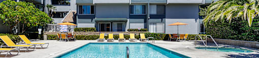 a swimming pool in front of an apartment building