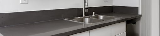 a kitchen with white cabinets and a sink