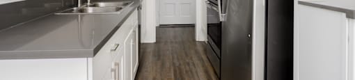 a kitchen with stainless steel appliances and white cabinets