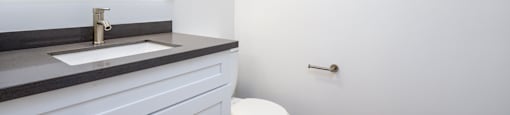 a bathroom with a toilet and a sink and a mirror