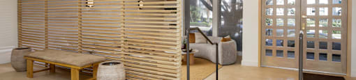 a living room with a wooden wall and a door
