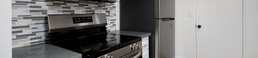 a kitchen with stainless steel appliances and a refrigerator