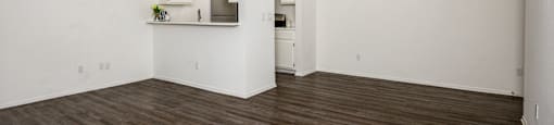 A room with wooden floors and white walls.