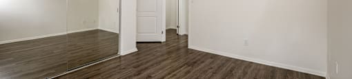 A room with a wooden floor and white walls.