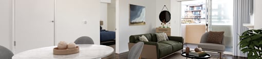 A modern living room with a white table and grey chairs.