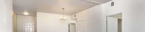 A large empty room with wood floors and white walls.