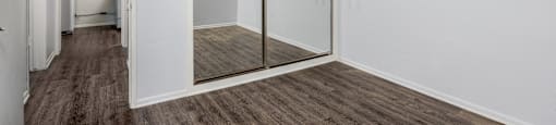 an empty room with a window and a ceiling fan