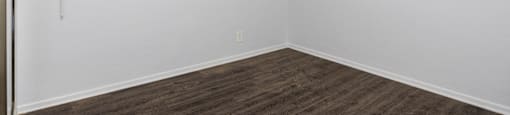 an empty room with a ceiling fan and a window