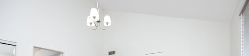 an empty living room with white walls and a wood floor