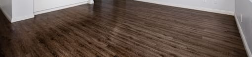 A room with wooden floors and white walls.