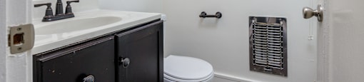 a bathroom with a sink and a toilet and a bath tub