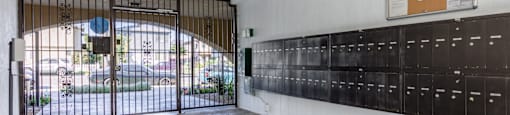 the entrance to a building with a gate and lockers