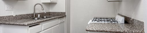 A kitchen with white cabinets and a granite countertop.