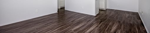 A room with wood flooring and a ceiling fan.