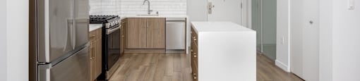 kitchen with white cabinets and stainless steel appliances and center island