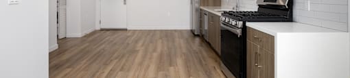 a kitchen with white cabinets and a stove and a microwave