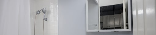 A white toilet and sink in a bathroom.