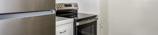 A stainless steel refrigerator with a blue sticker on it.
