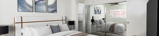 A bedroom with a large bed and a ceiling fan.