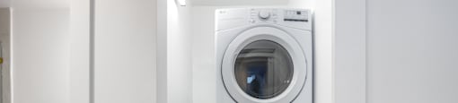 a white washer and dryer in a white laundry room
