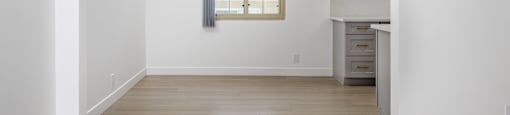 a living room with white walls and a window