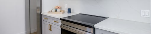 a kitchen with white cabinets and a stainless steel refrigerator