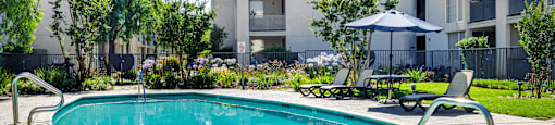 a swimming pool in front of an apartment building