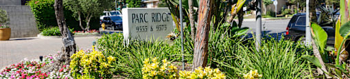 a park ridge sign in a garden of flowers