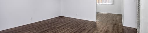 Empty room with wooden floor and white walls.